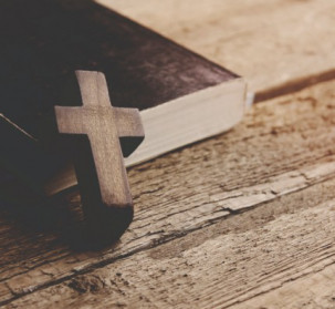 A cross against a bible